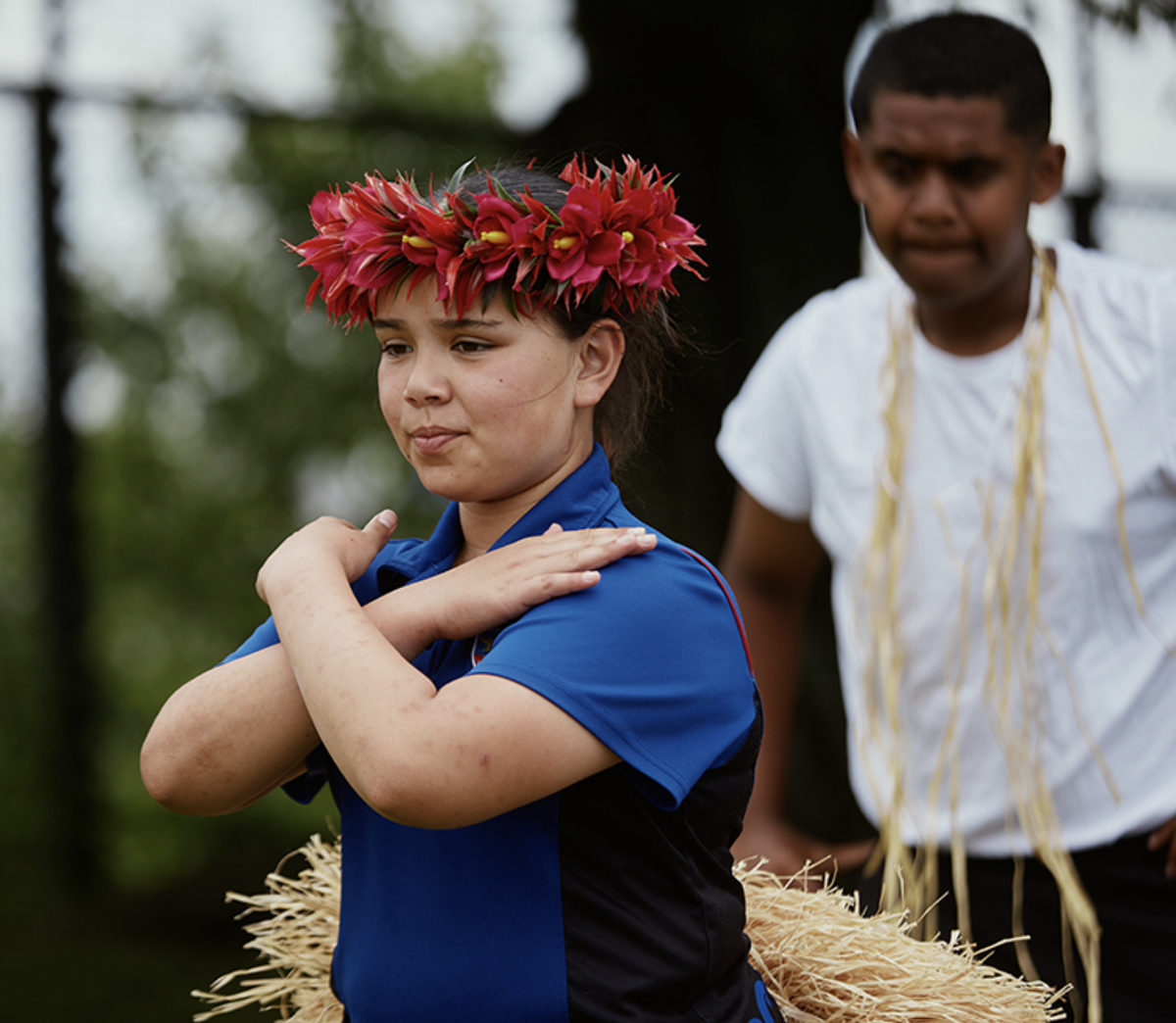 Maeroa Intermediate student performing a cultural dance wearing a flower headpiece.